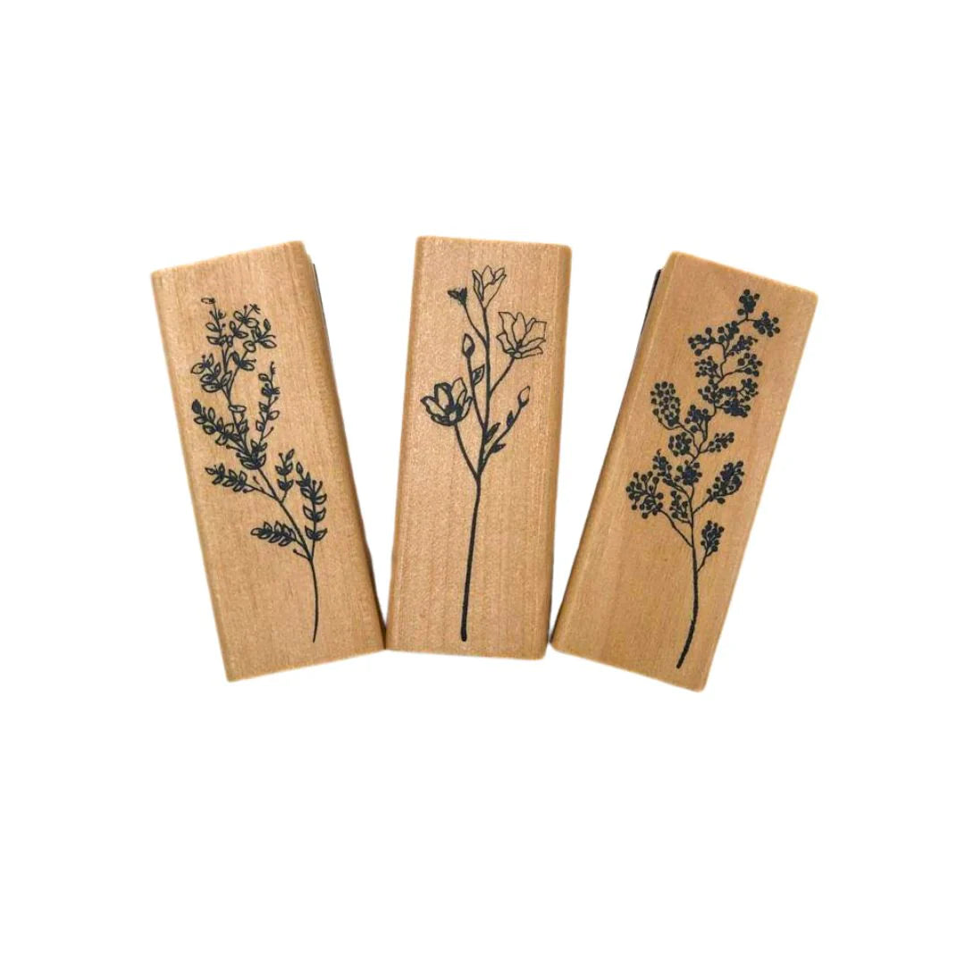 Three Wooden block Stamps with floral designs on a white background