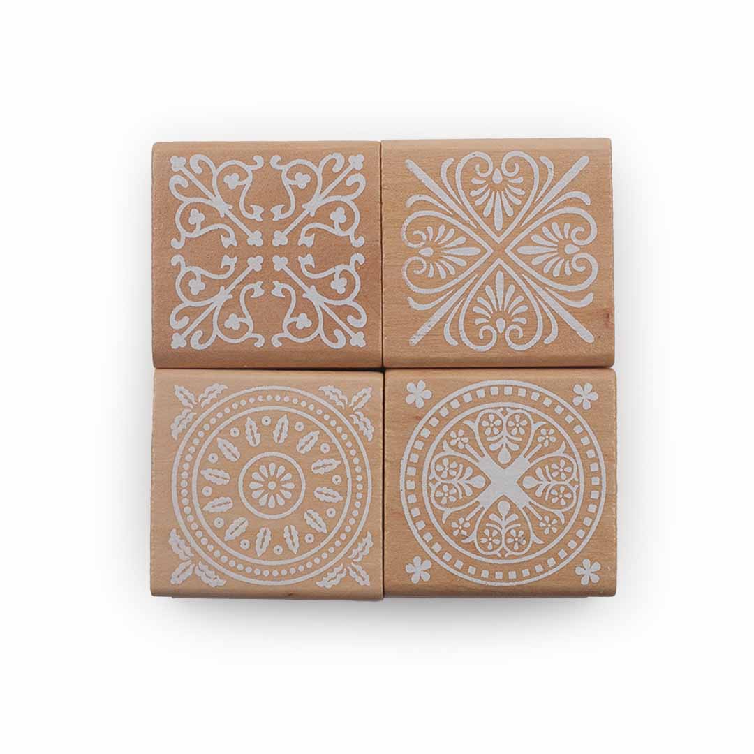 Four brown square tiles Wooden block Stamps with white decorative patterns on a white background